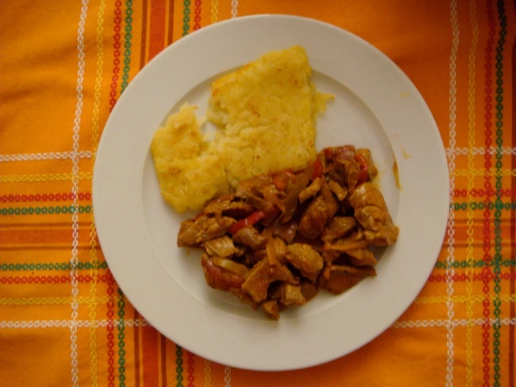 a white plate topped with meat and vegetables