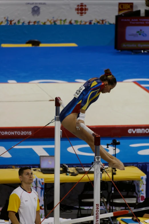 a woman is on the bars and is standing