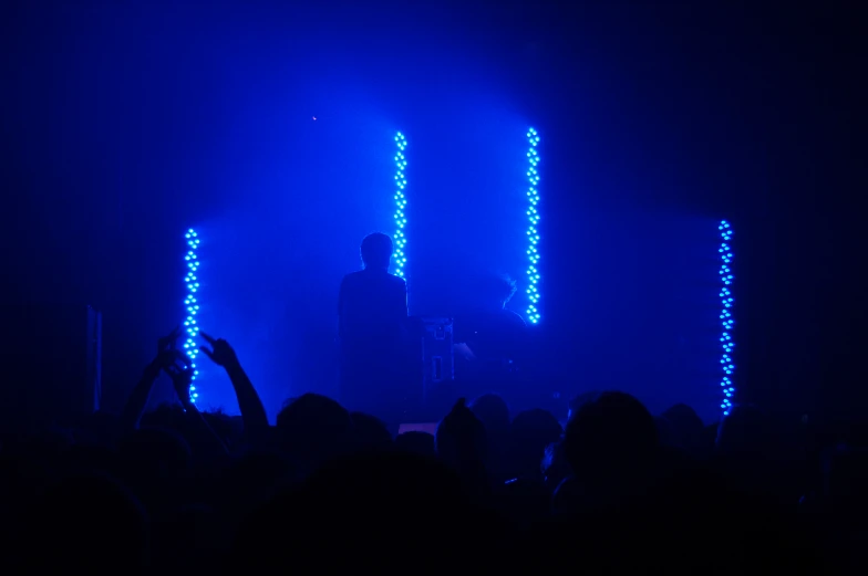 a couple of people that are standing in the dark