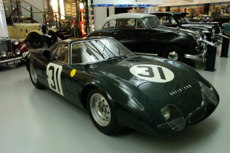 several race cars are in a museum display