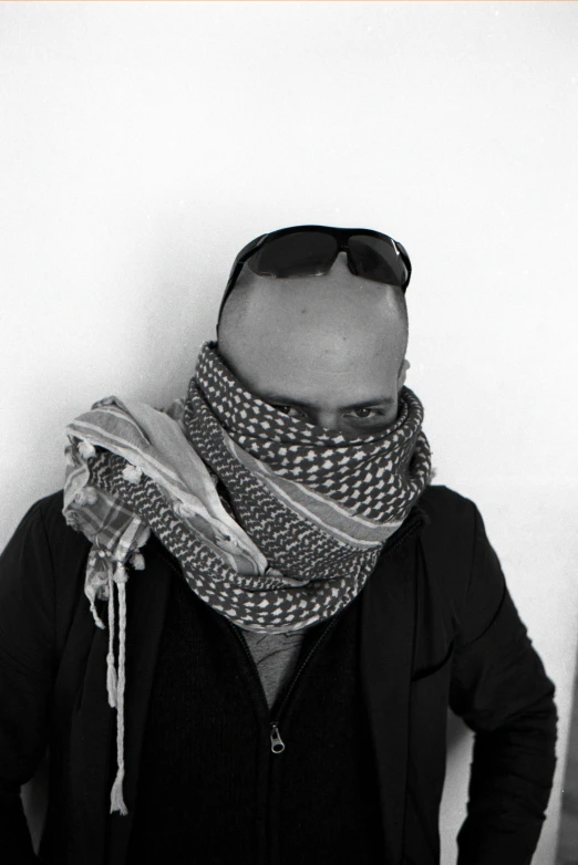 a black and white po with shades, a scarf and sunglasses