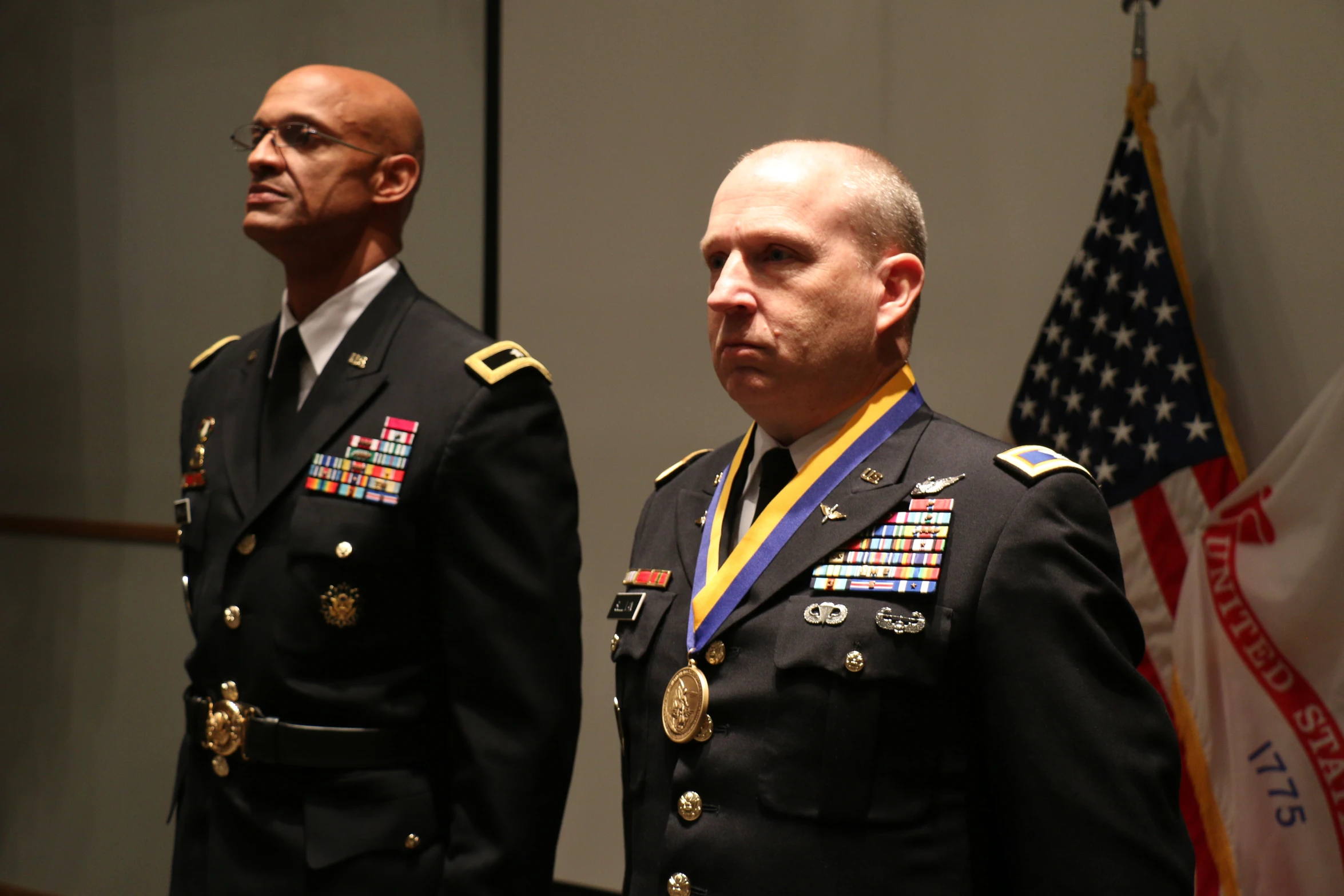 two men in military uniforms standing next to each other