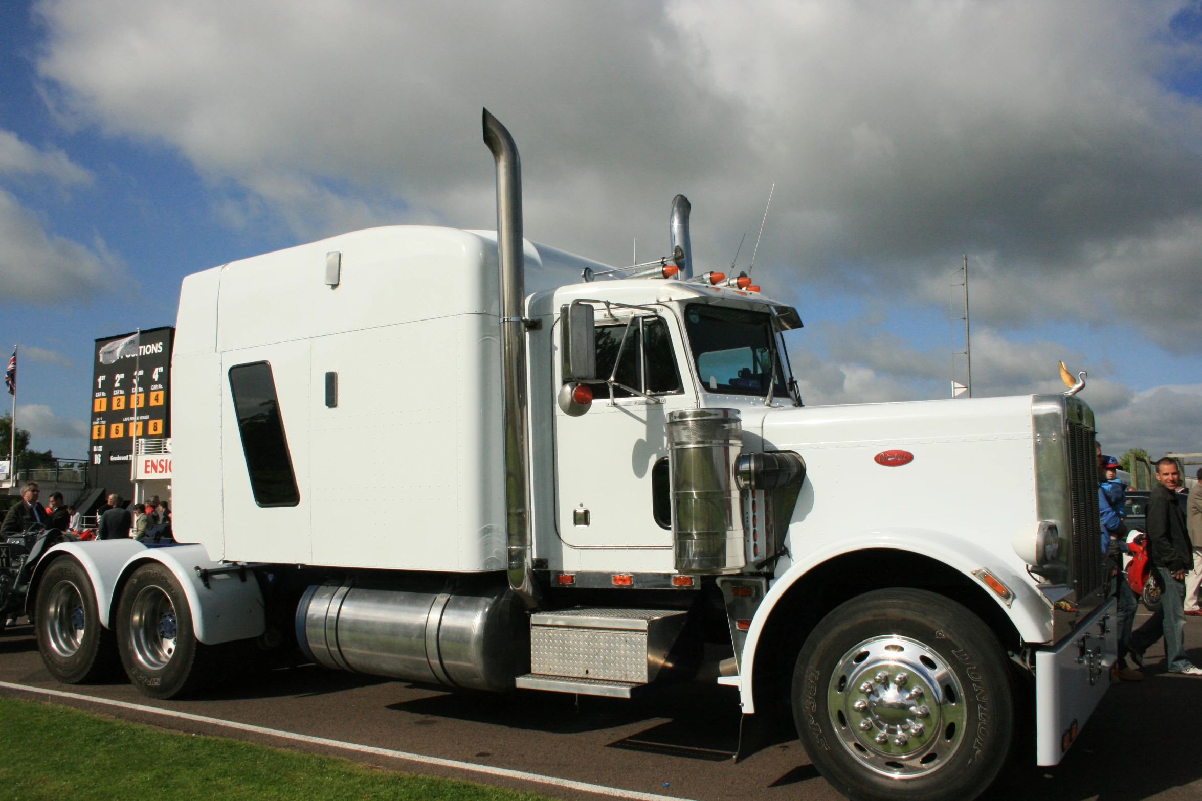 an eighteen wheeler truck parked on a road