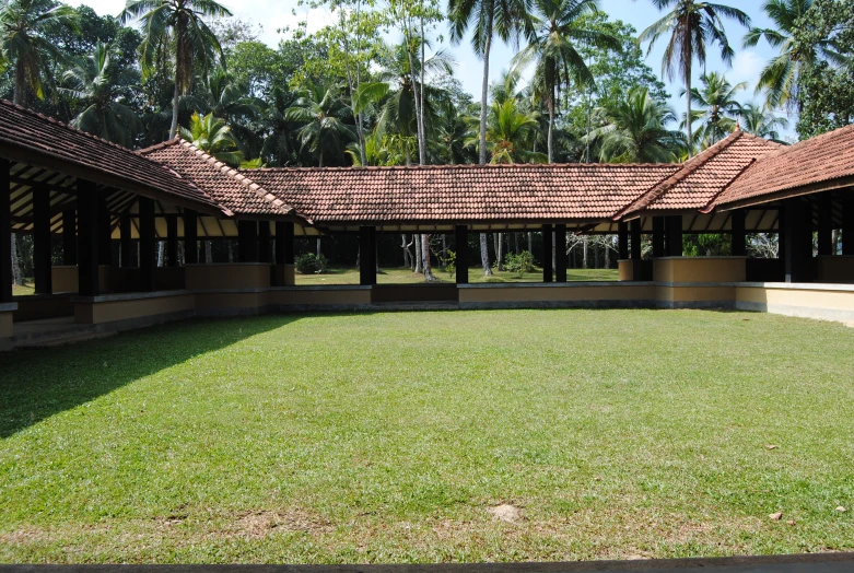 a large green field sitting under a large pavilion