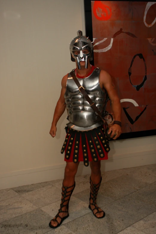 a man in a gladia costume stands next to a painting