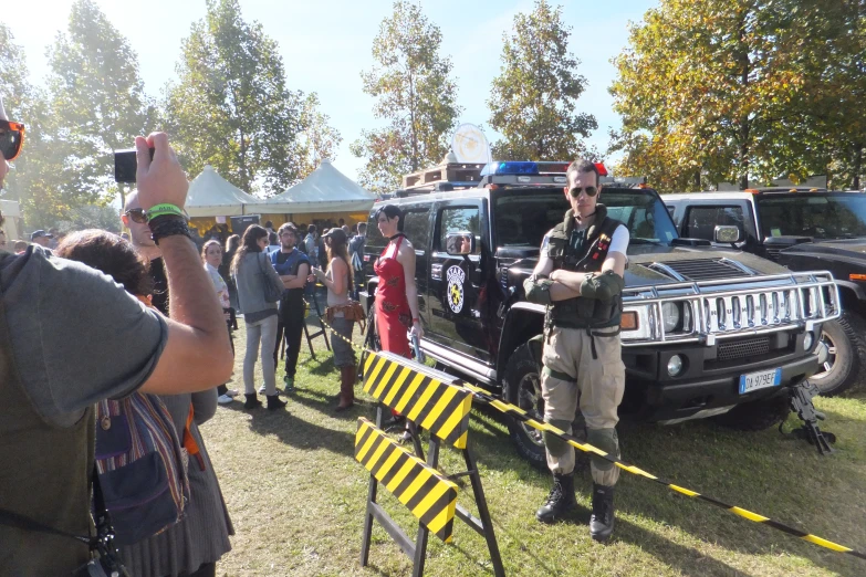 a truck with its doors open, with a policeman on it's back