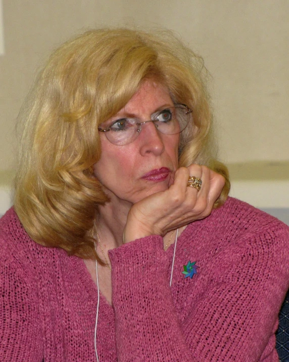 a woman sitting at a desk looking into the distance