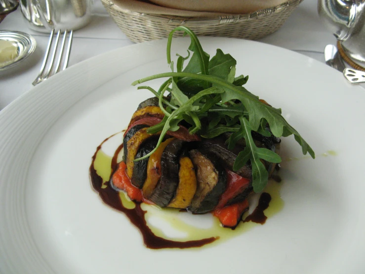 a white plate topped with a colorful vegetable dish