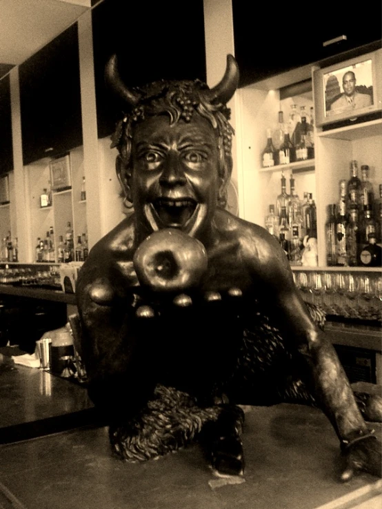 an old statue sits behind the bar counter