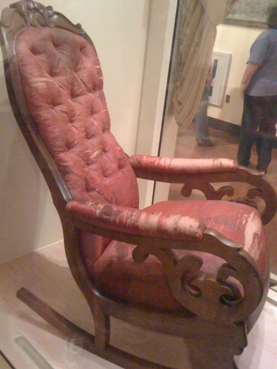 an old rocking chair on display in a museum