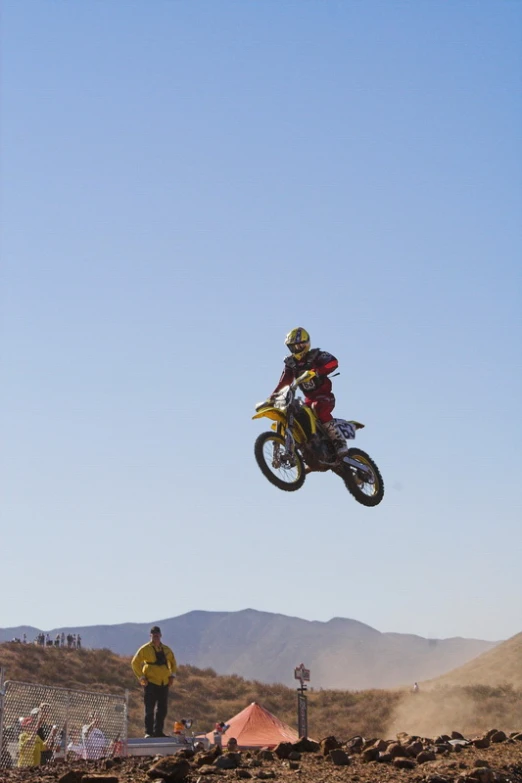 a man riding a motorcycle flying through the air