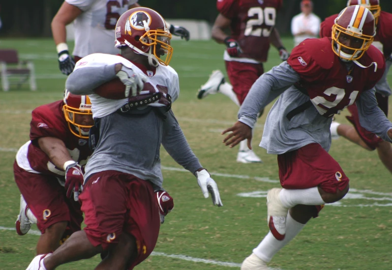 a football team runs in unison for the football