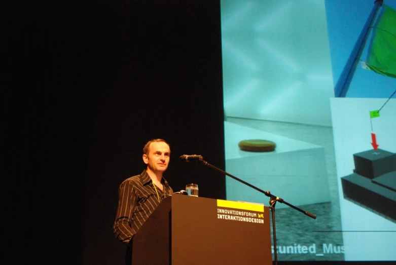 a man standing at a podium and giving a speech