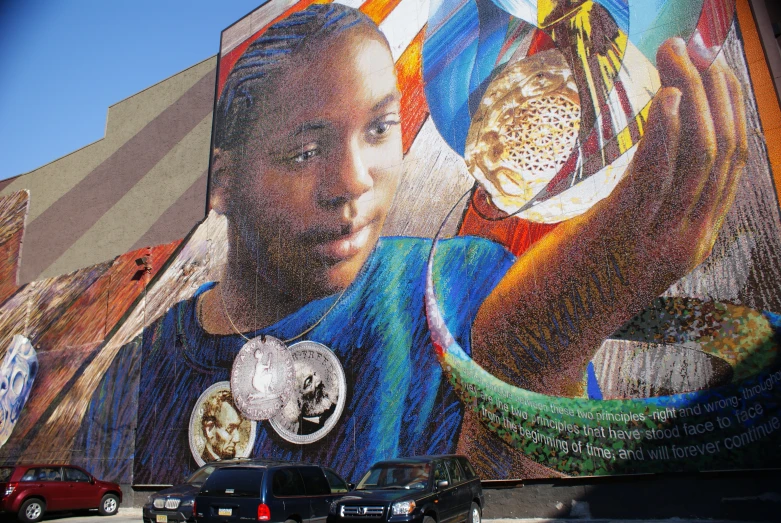 a large, colorful wall mural is on the side of a building