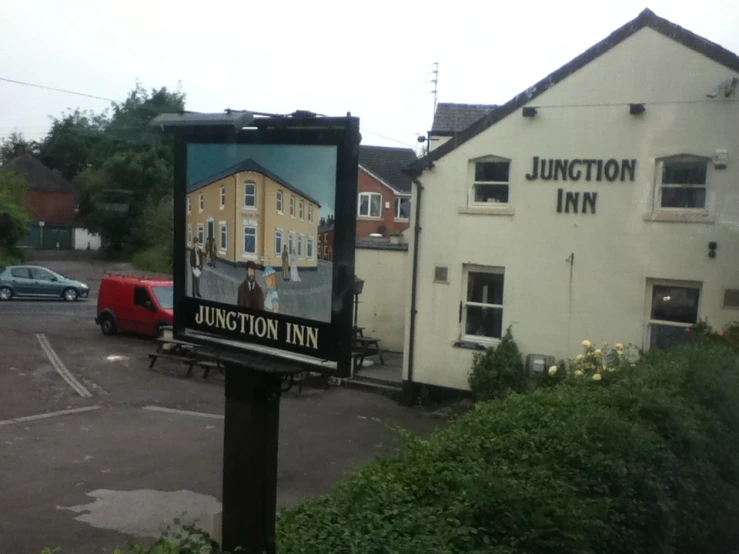a po of junction inn on a sign in a parking lot