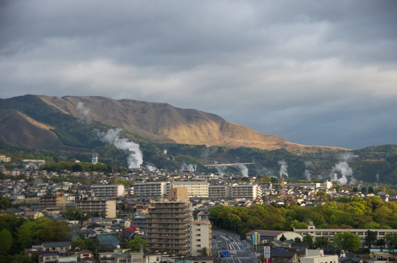 a city with steam emitting from some buildings