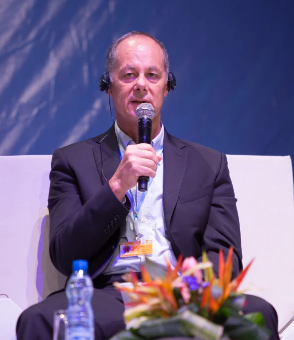 man with headphones on speaking into a microphone