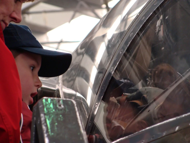 the young man and woman are standing in a car