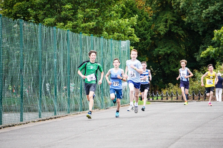 several young people are jogging in a marathon