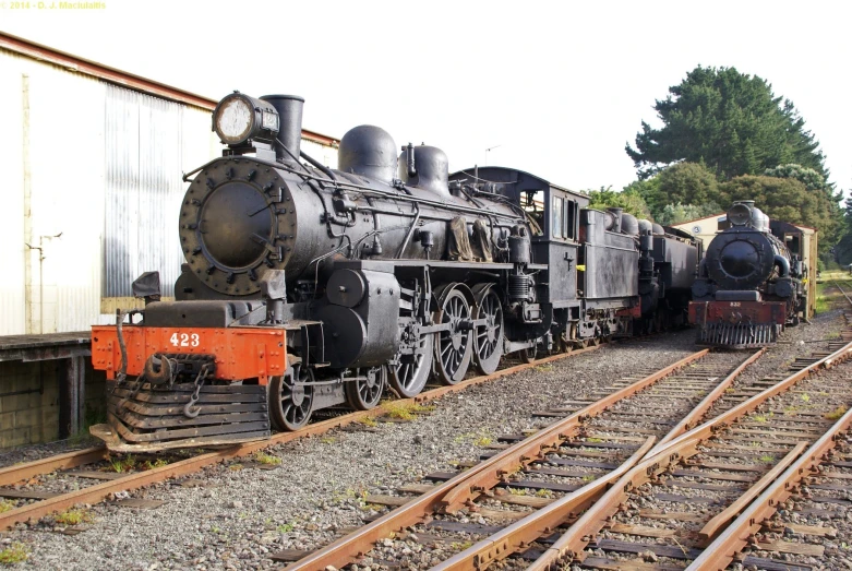 the old time steam train is coming down the tracks