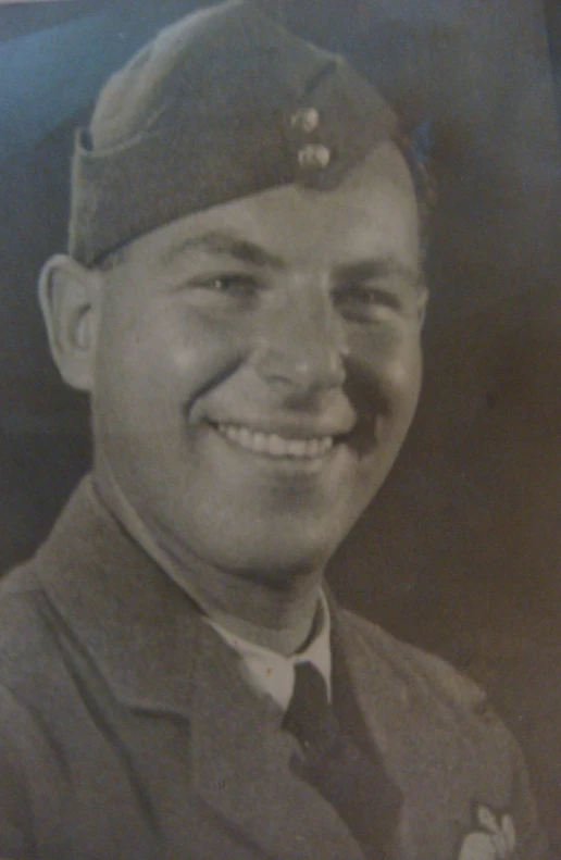 a man in uniform smiles at the camera