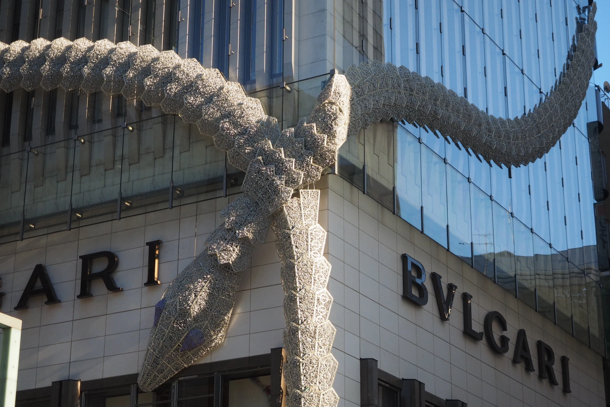 sculpture outside of building and tree on street