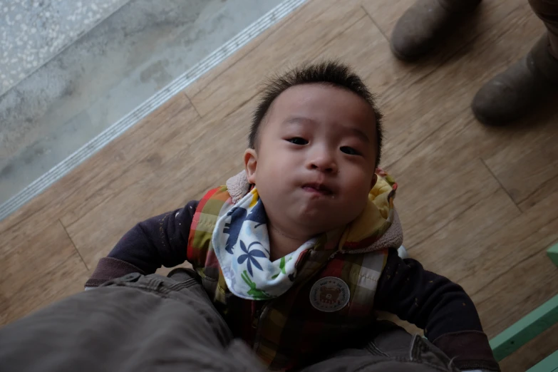 the child is wearing a bandanna and looking at the camera