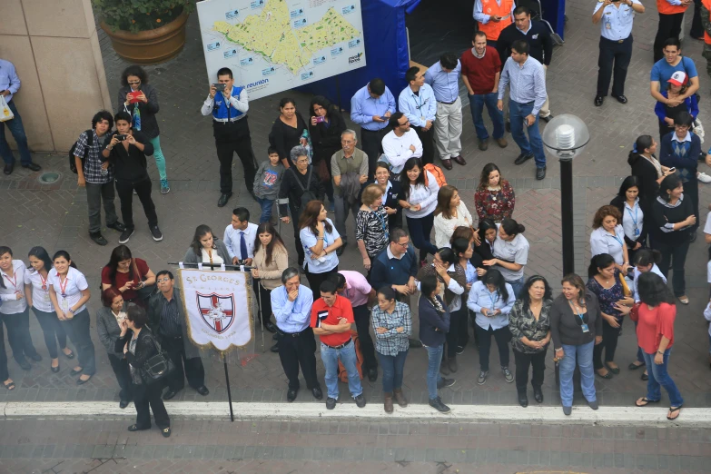 many people are standing in a street area