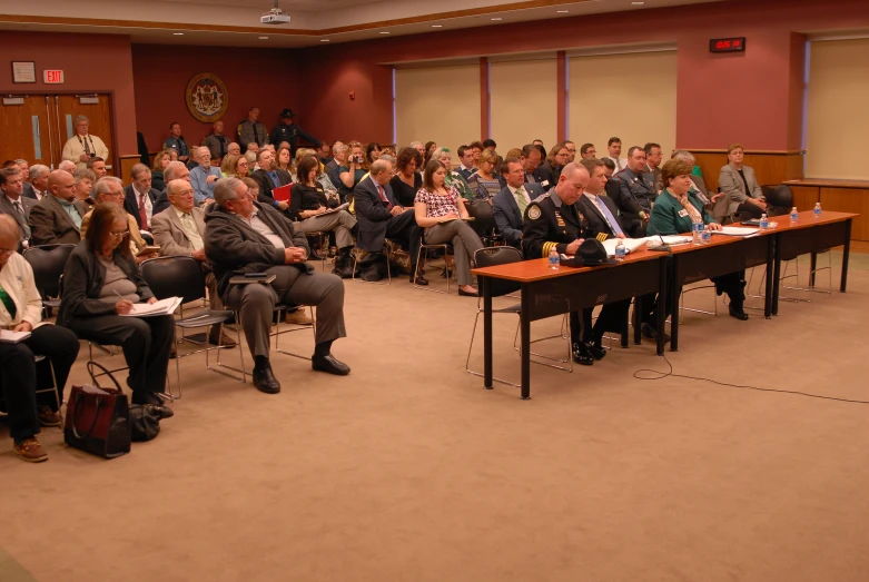 people are seated in a conference room for a presentation