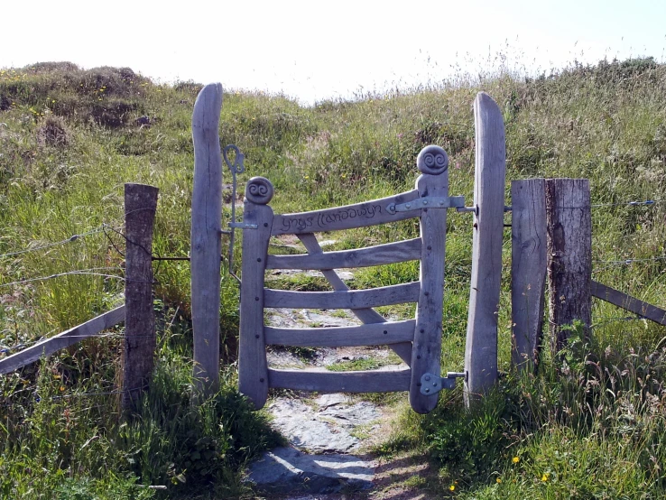 an open wooden fence sitting on top of a hill