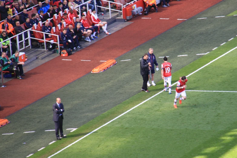 two teams are being watched by the players in a field