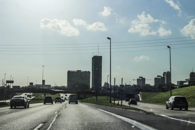 cars and trucks are driving on a freeway in the city