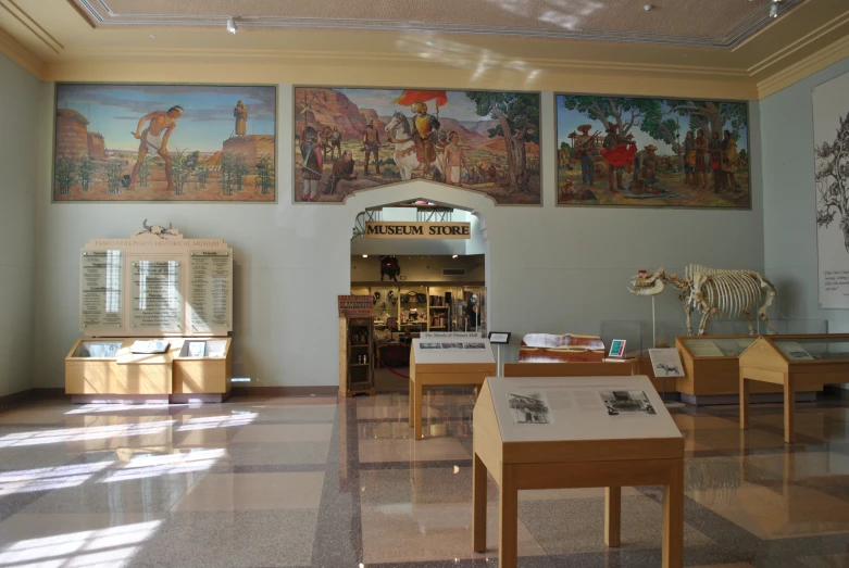 many paintings and sculptures are displayed on the walls