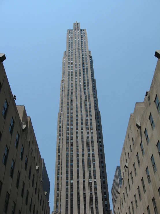 the top of three skyscrs are tall with windows