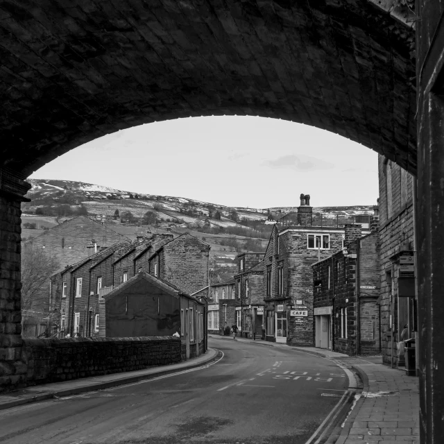 the street beneath an arch leads into the city