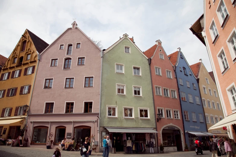 an image of a row of colorful buildings with people walking