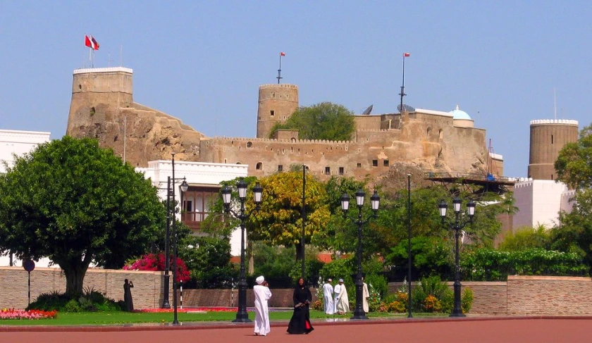 two people walking in a park near the castle