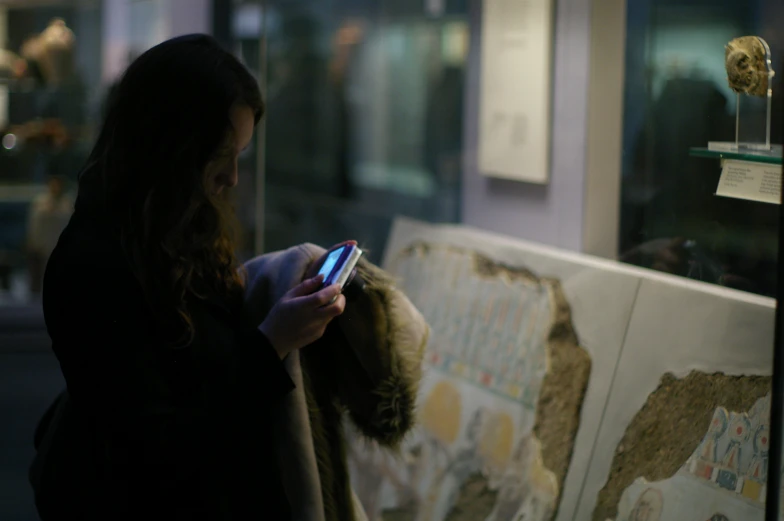 a woman looking at a map using a cell phone