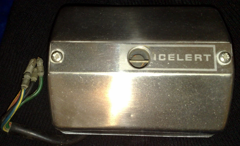 an old silver electronic device that is connected to a wiring