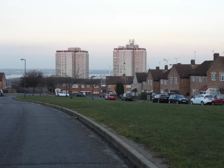 a group of brick buildings standing over a green field