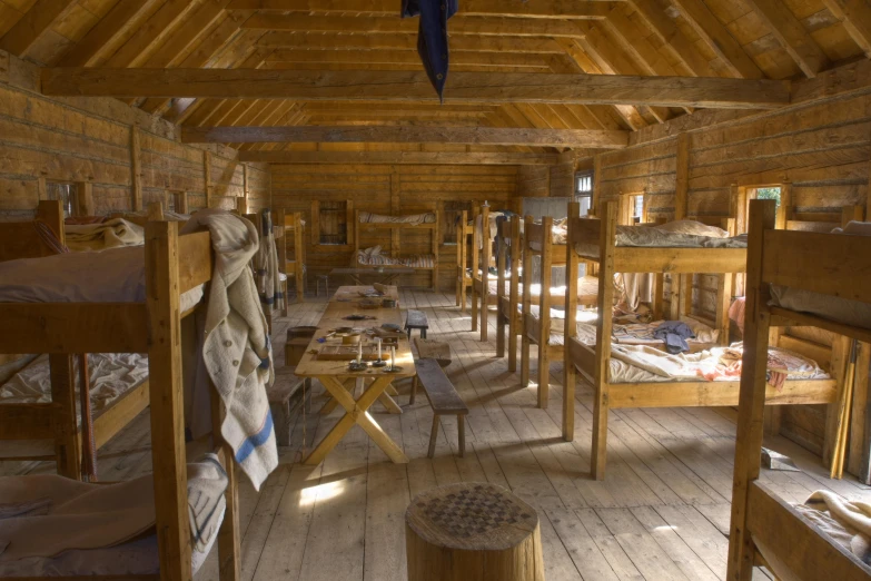 a bunch of bunk beds in a room with wooden floors