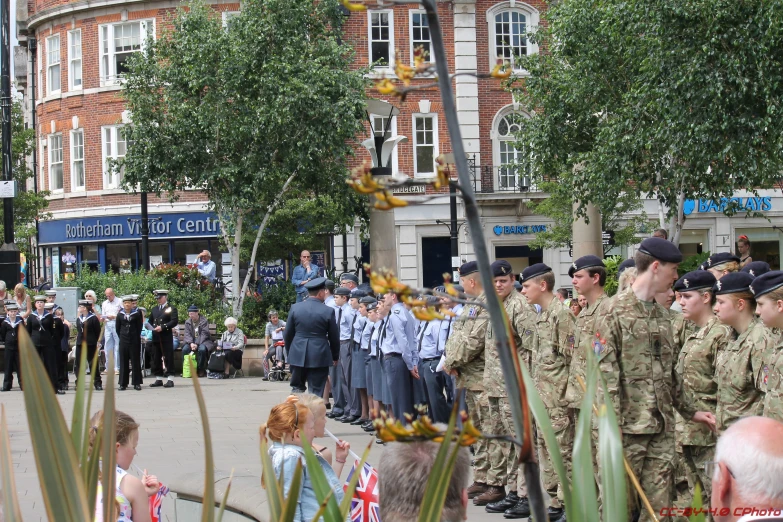 some soldiers standing in a circle talking to people