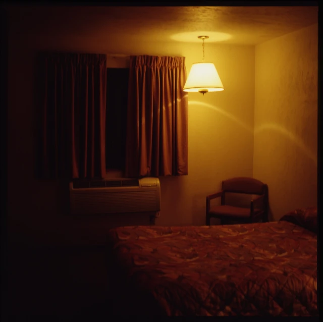 the bedroom is dimly lit and features a bed