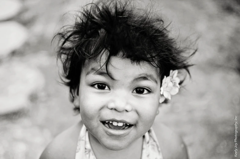 a little girl smiles and plays with a hairbrush