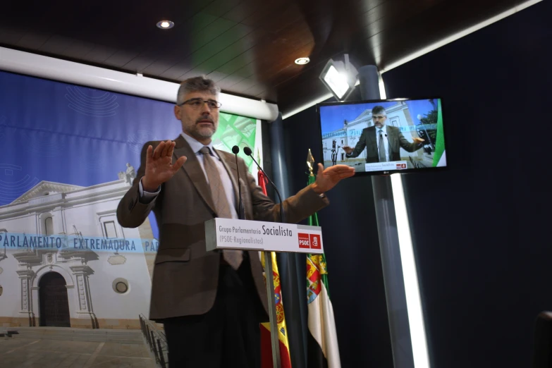 a man standing and presenting his project during an event