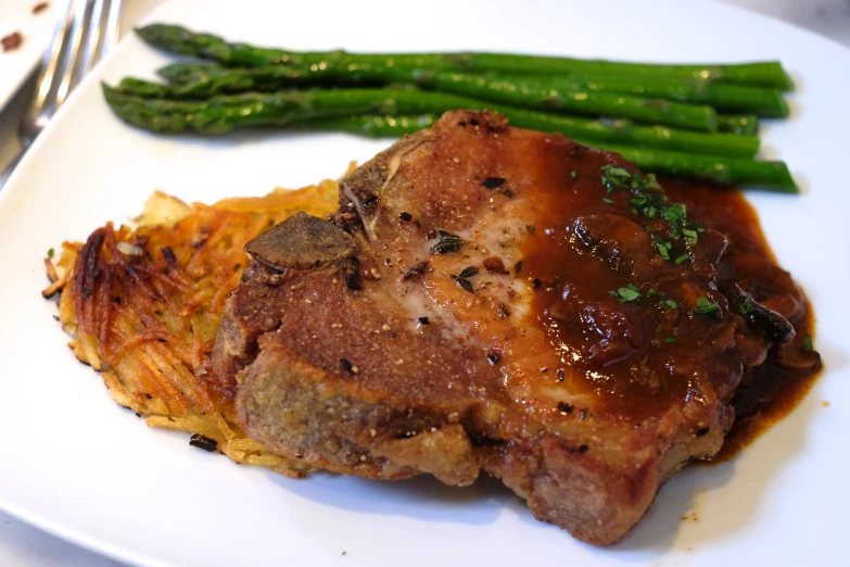 a plate topped with meat and vegetables on top of a table