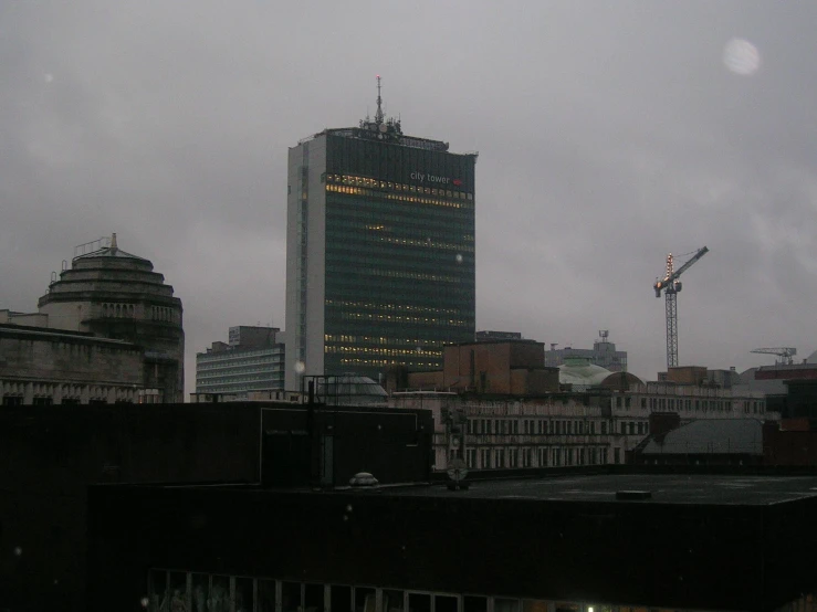 a tall building and other buildings near some buildings