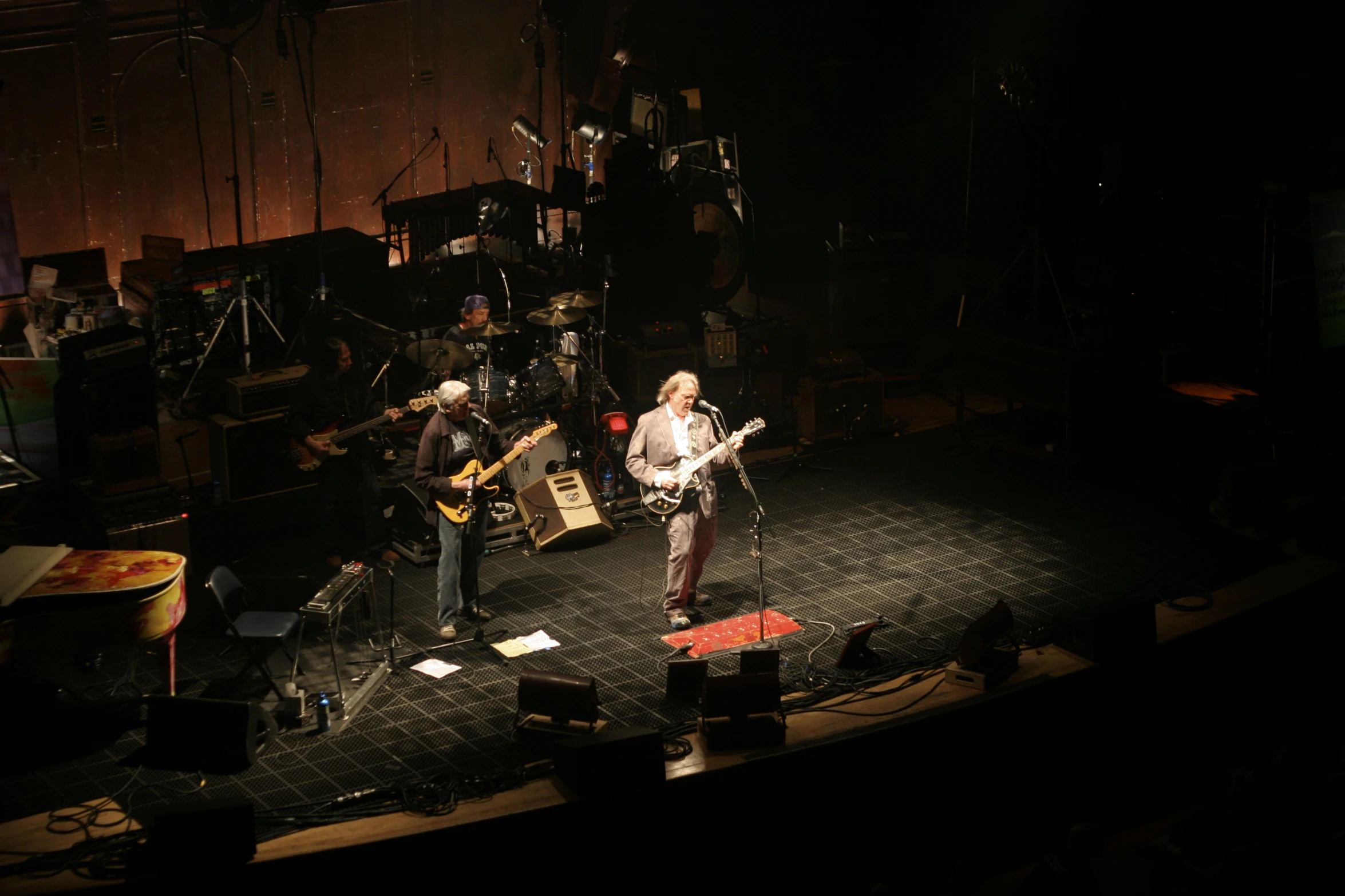 three people are playing on the stage together