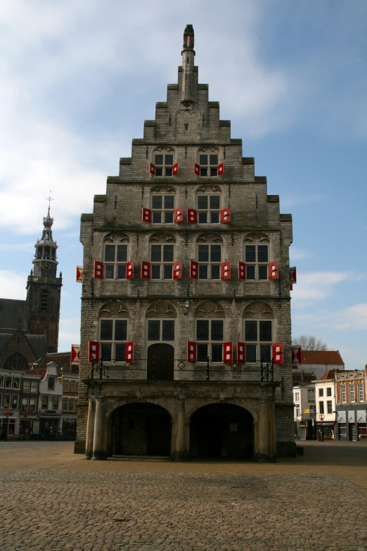 an old building with lots of windows and red decor