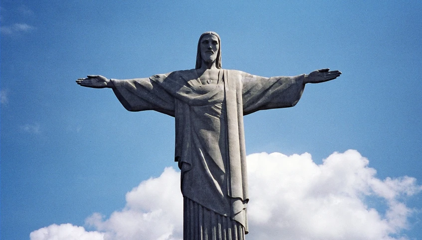 christ of jesus statue surrounded by blue sky and white clouds